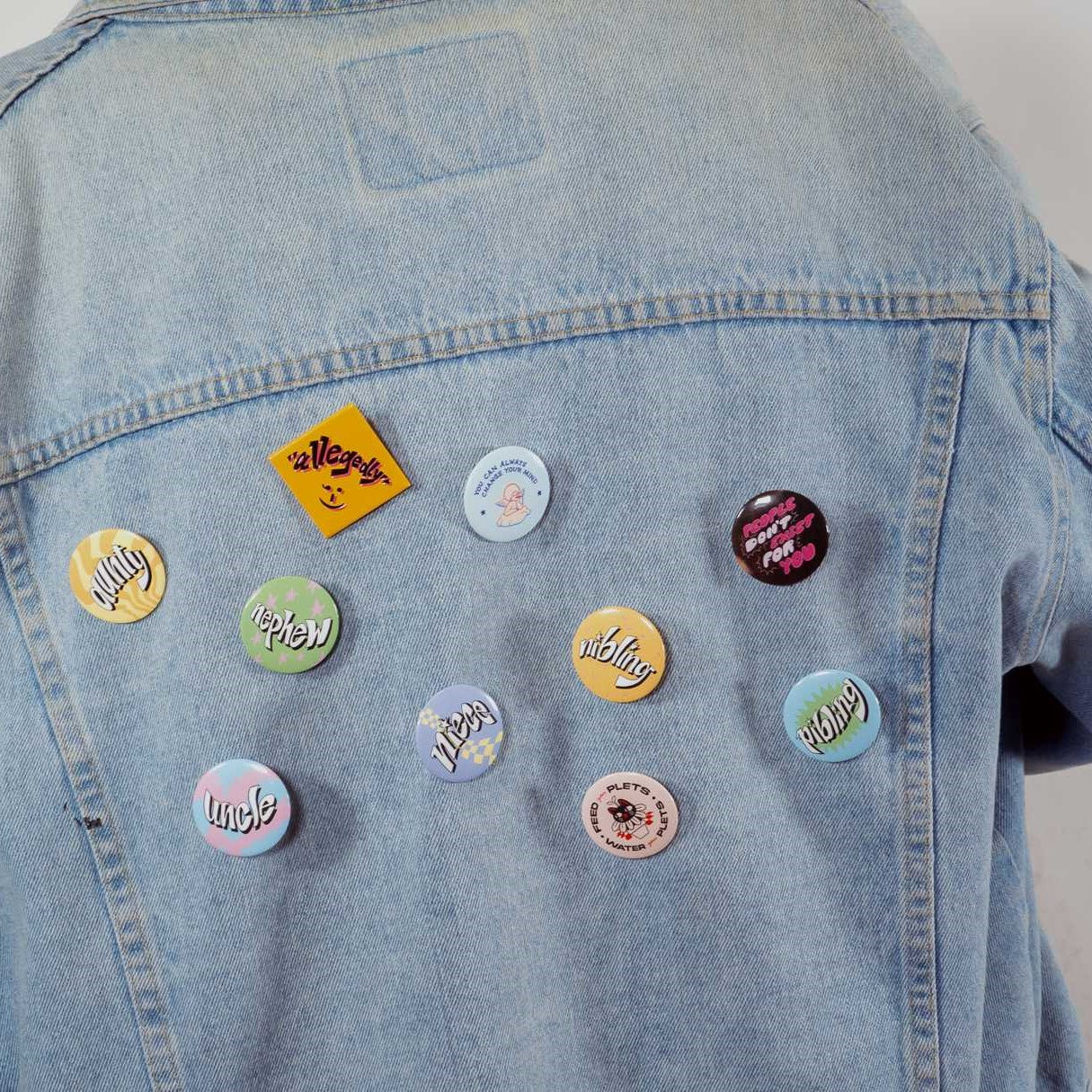 All the pins shown on the back of a denim jacket.