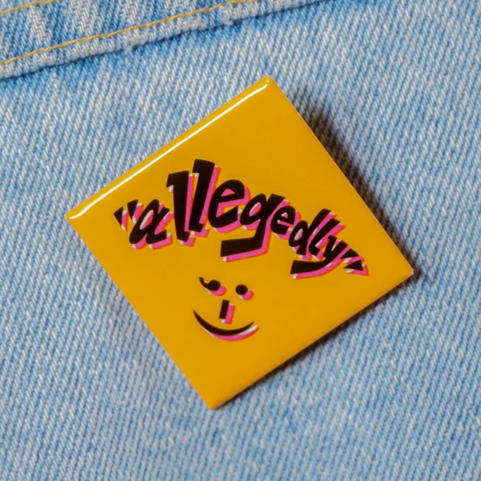 Orange diamond-shaped pin with text that says "allegedly ;-)"